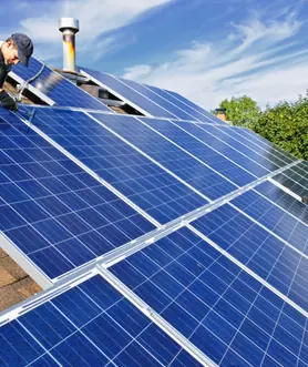 Installers mounting a solar panel