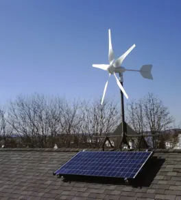 Solar farm with wind turbines at sunset